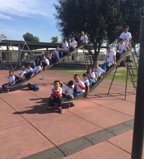 Our scholars celebrate their literary achievements with their new t-shirts, awarded by our staff.